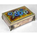 A plated desk top cigarette box with brightly coloured blue enamelled flowers to the lid,