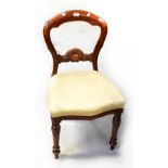 A Victorian mahogany balloon back dining chair with carved central rail,