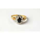 A 9ct yellow gold ladies' dress ring, floral set with central sapphire and small diamond chips,