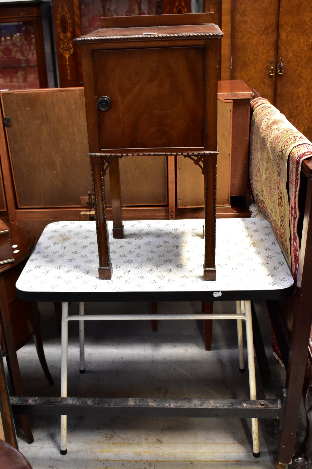 A retro c1950s melamine kitchen table, to tubular white metal frame,