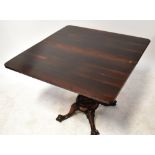 A 19th century rosewood fold-over tea table to carved baluster and quadripartite support,