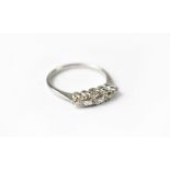 A five-stone diamond and platinum ring, with five claw set graduated diamonds,