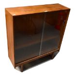 A c1960s retro glazed teak bookcase with pair of sliding doors,