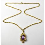 A hallmarked 9ct gold pendant, with claw set oval amethyst cut stone,