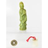 A jadeite figure, 15cm tall (af) and two Oriental tokens to include a jadeite example (3).