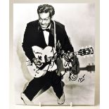CHUCK BERRY; a black and white photograph of the star with inscription, signature and doodle, 25.