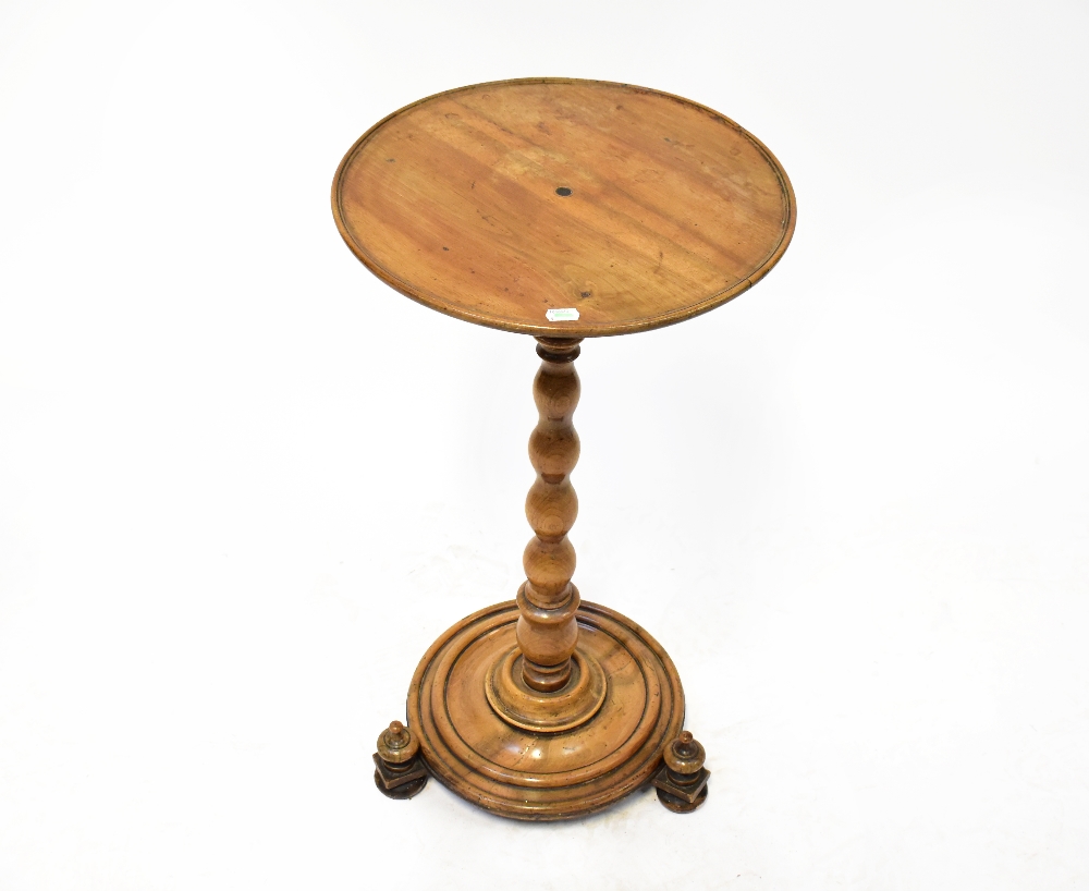 A 19th century mahogany circular top side table, on a turned column and circular base,