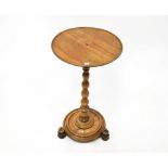 A 19th century mahogany circular top side table, on a turned column and circular base,