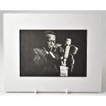 MILES DAVIS; a cut photograph from a book or magazine bearing the Jazz star's signature, 11.5 x 16.