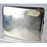 MILITARY INTEREST; a George V hallmarked silver cigarette box of cushioned rectangular form,