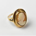 A 9ct gold ring with bezel set centred shell cameo depicting a bust of a lady,
