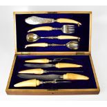 An early Edwardian oak cased set of hallmarked silver and ivory handled serving cutlery to include