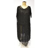 A 1920s black silk chiffon flapper tabard dress, the underdress with various panels,