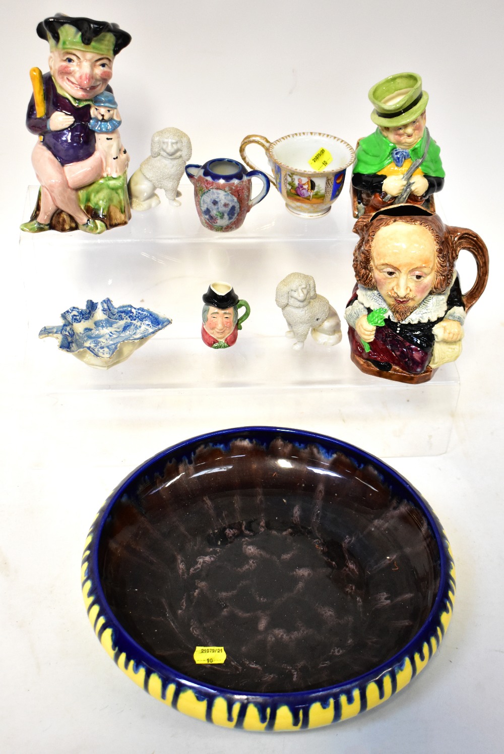 Various antique and vintage collectible pottery items to include a large yellow and green shallow