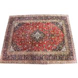 A hand knotted red ground Kashan Persian carpet,