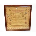 A 19th century alphabet and verse sampler within a floral scroll border,