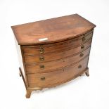 A 19th century mahogany bow front chest of four long graduated drawers with brushing slide above