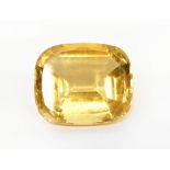 An emerald cut yellow stone, citrine, approx 2.7 x 2.2 x 1.5cm.