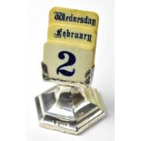 A George V hallmarked silver desk calendar with ivorine inserts for days of the week,