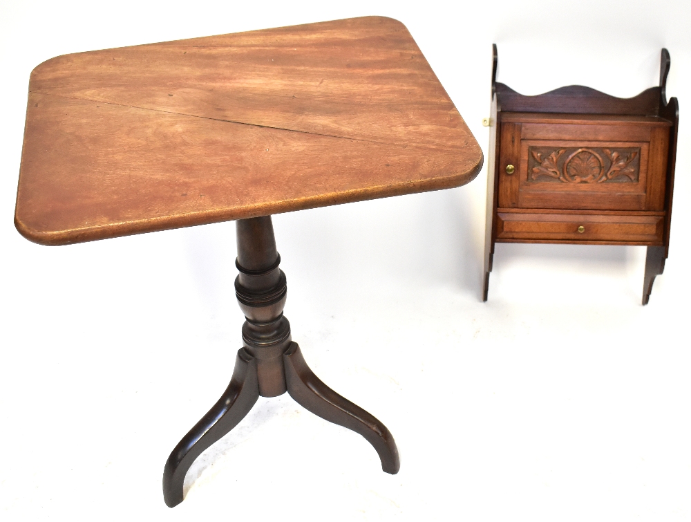 An early 19th century mahogany tripod table with tilt top and catch,