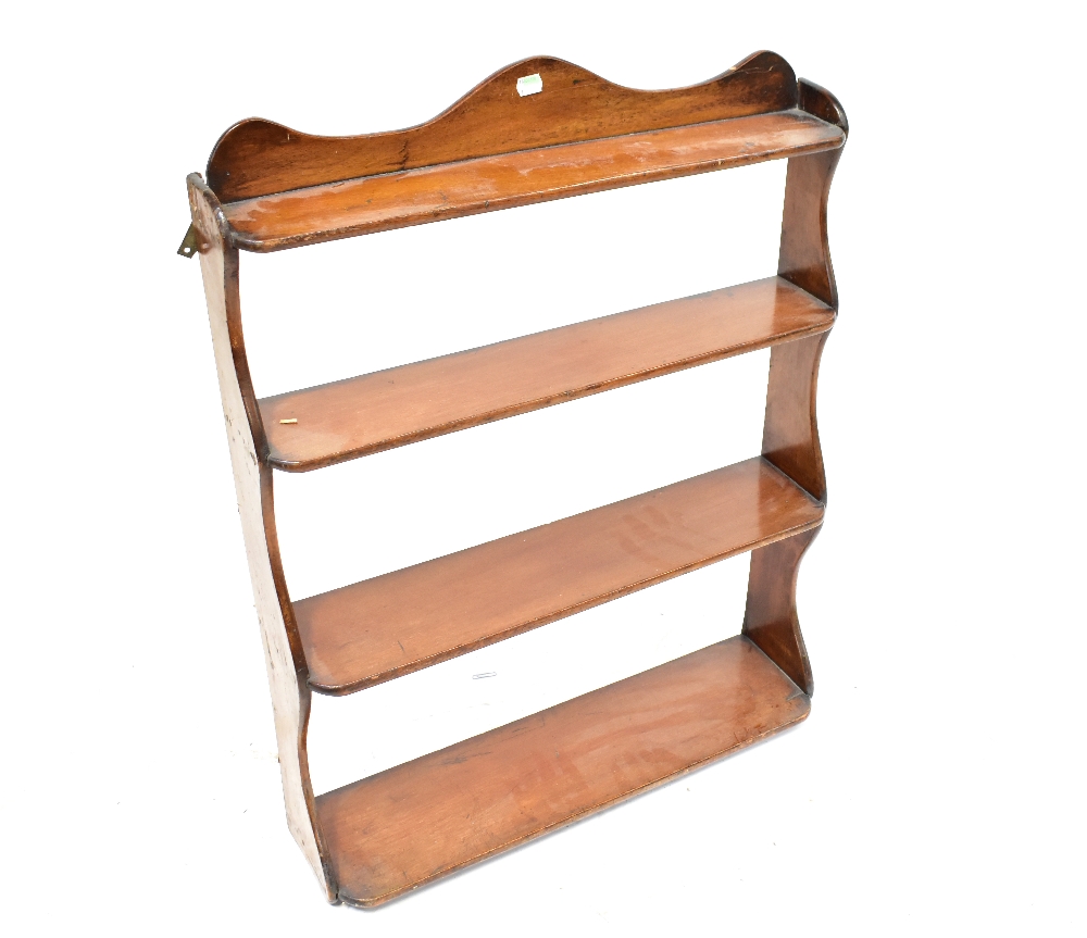 A 19th century mahogany wall-hanging waterfall shelf unit, with curved top, 82 x 63.5 x 19cm.