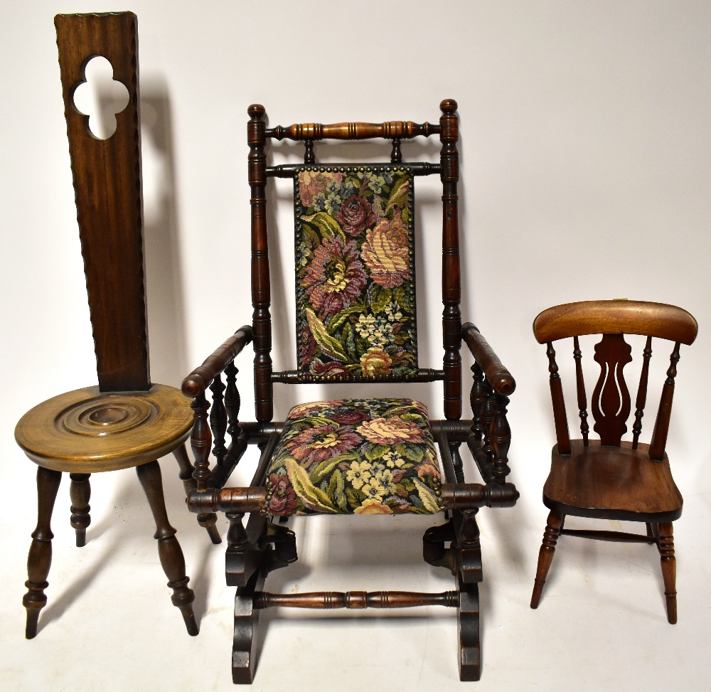 A children's Victorian-style rocking chair with upholstered seat and back,