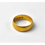 A 22ct gold wedding band of cushion form, hallmarked 22, approx 5.2g.