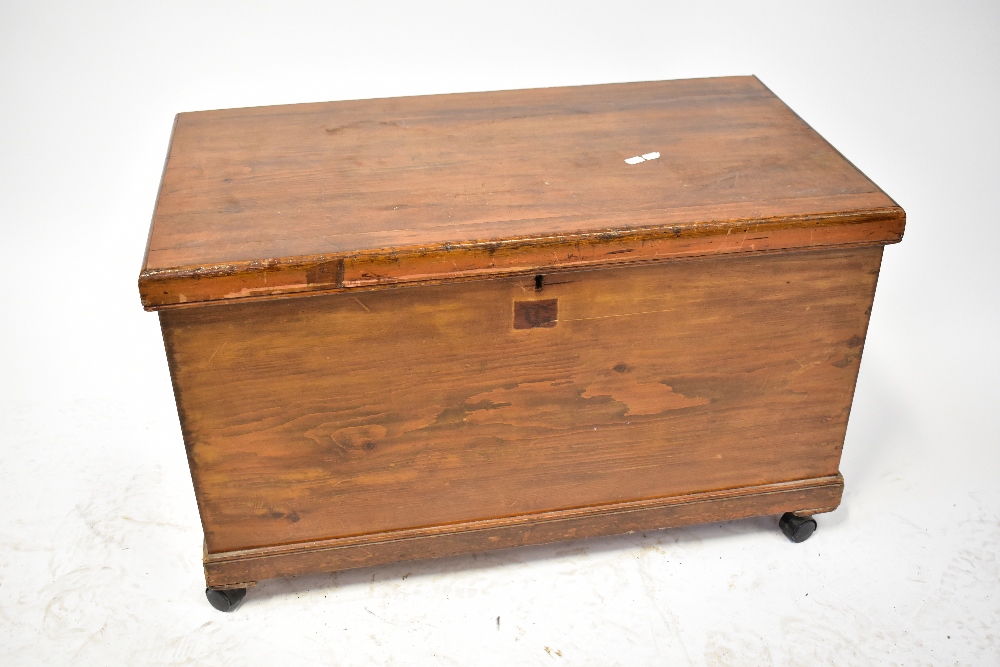 A 19th century stained wooden chest with iron drop handles,