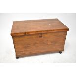 A 19th century stained wooden chest with iron drop handles,