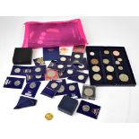 A collection of various coins and tokens to include twelve football commemorative tokens including