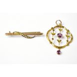 A 9ct gold bar brooch with seed pearl clad leaf and an unmarked yellow metal necklace drop with