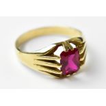 A gentlemen's 9ct yellow gold dress ring with central emerald cut ruby, size S, approx 3.9g.