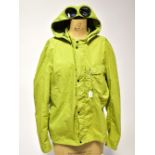 CP COMPANY; a jacket in green with detachable hood,