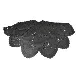 A 360 degree black cape with cutwork and beaded decoration of floral and oval motifs and with