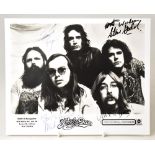 STEELY DAN; a black and white promotional photograph bearing the five band members' signatures, 20.