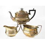 A George V hallmarked silver three-piece tea set of Neo-Classical style, comprising a teapot,