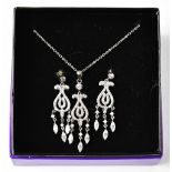 A silver necklace with diamante drop pendant and a pair of matching earrings, stamped 925.
