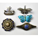 Four silver brooches comprising an enamelled blue and red dotted butterfly,