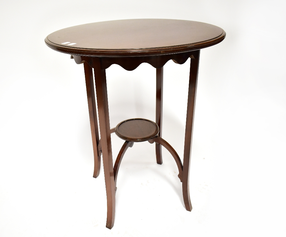 An Edwardian mahogany circular occasional table with simple frieze,