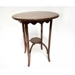 An Edwardian mahogany circular occasional table with simple frieze,