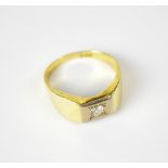 A gentlemen's yellow metal dress ring with illusion set small diamond, size Y.
