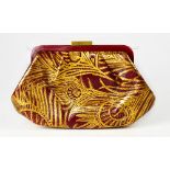 LIBERTY OF LONDON; a red and gold leather clutch bag in peacock design,