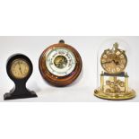 A small desk clock of balloon shape, the ebonised wooden body with barrel movement, height 13cm,