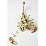 A 9ct gold brooch in the form of a scorpion, set with graduated opals to the body and claws,