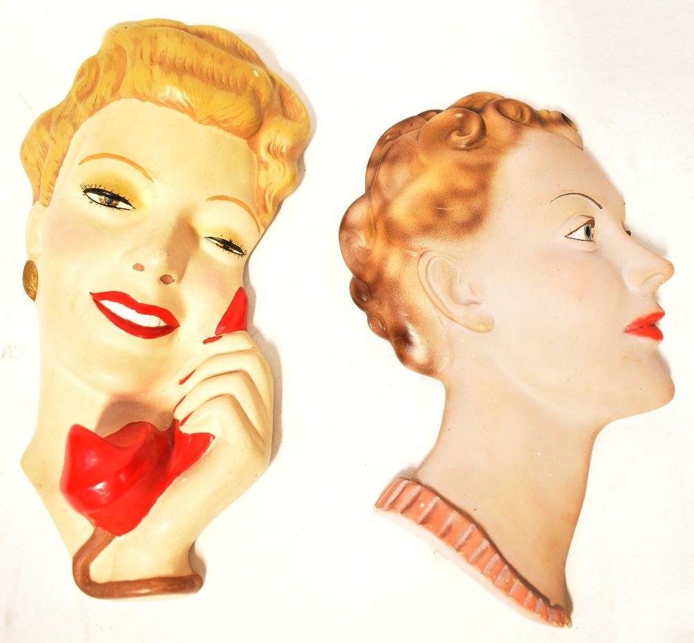 Two Art Deco wall-mounted pottery/plaster wall masks, both depicting the head of an elegant lady,