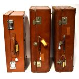 A pair of early 20th century Pendragon brown rigid suitcases, with brown leather trim,