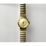 ACCURIST; a ladies' 9ct gold wristwatch on a gold plated flexi strap.