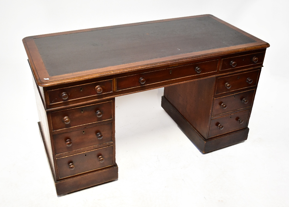 A Victorian mahogany twin pedestal desk with leather inset top over one long drawer and each