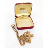 A 15ct yellow gold ropetwist chain and a large yellow metal cross with chased floral and foliate