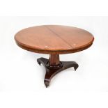 A 19th century mahogany circular tilt-top breakfast table with hexagonal column and raised on
